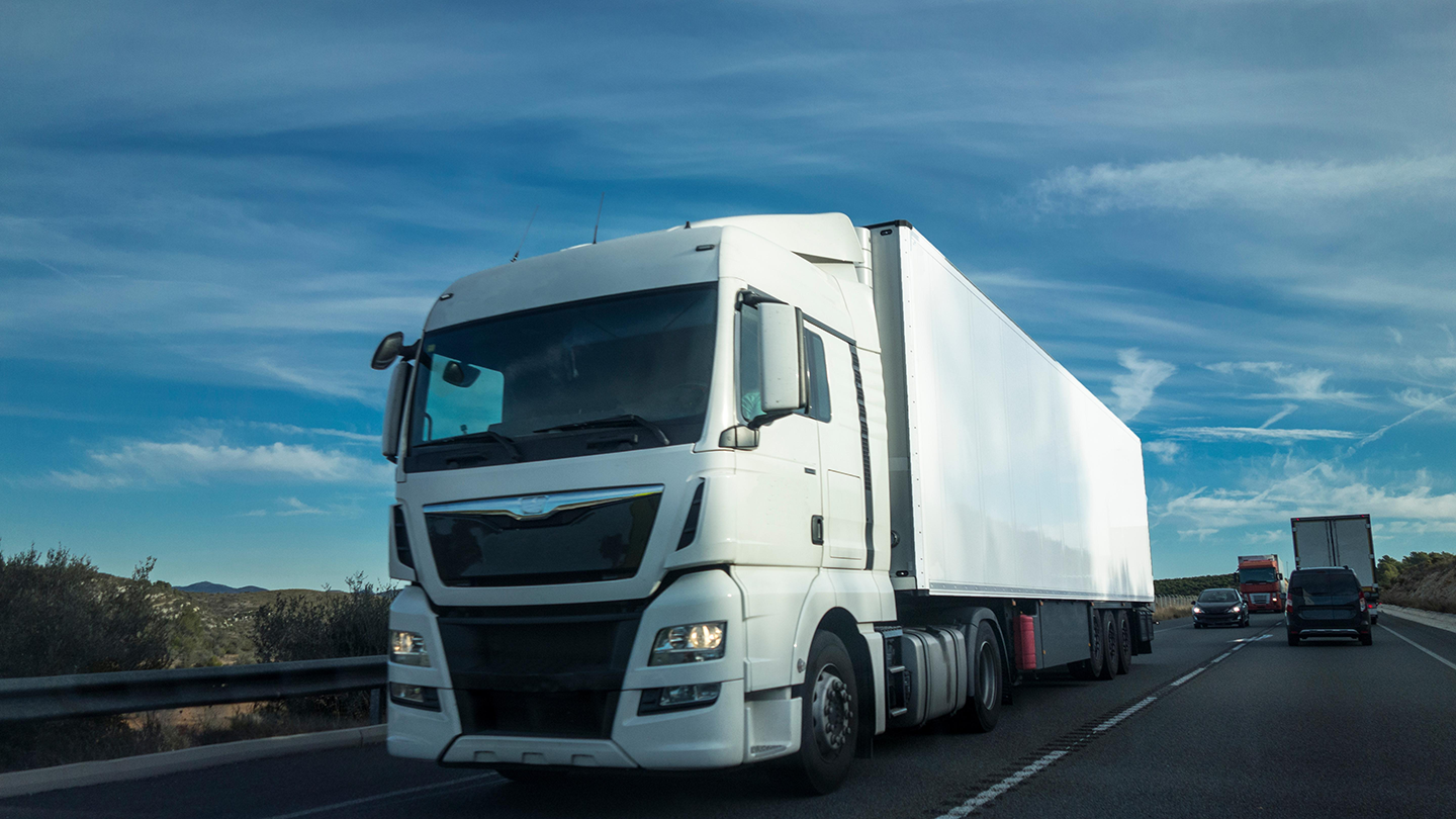 white-truck-on-highway-with-clouds-2026-03-17-00-31-09-utc